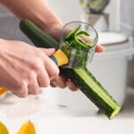 Compact vegetable peeler with container for mess-free peeling, perfect for prepping vegetables without leaving a mess on countertops