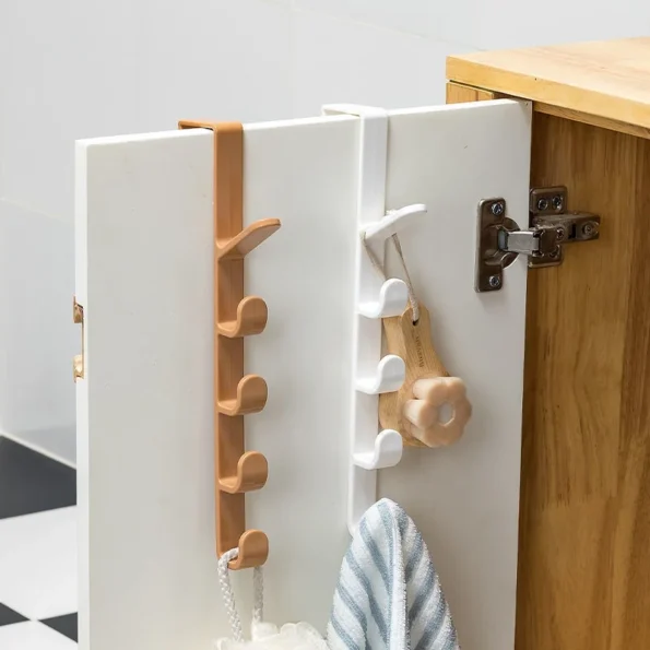 Space-saving over-the-door hat rack for small apartments, maximizing vertical storage by utilizing unused door space efficiently